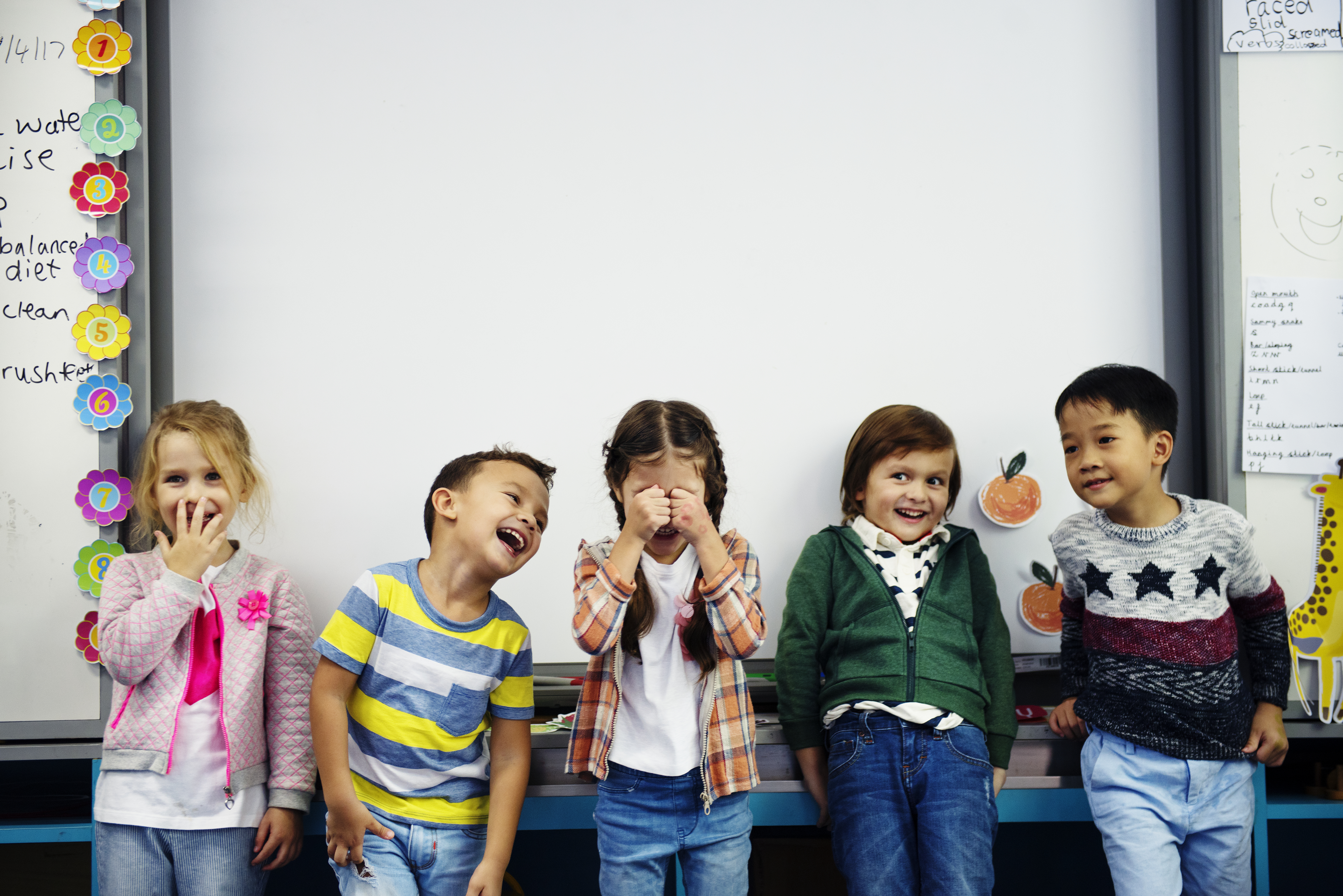 Teacher guiding children at Kidzopia Preschool